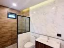 Modern bathroom with wood accents and marble wall tile