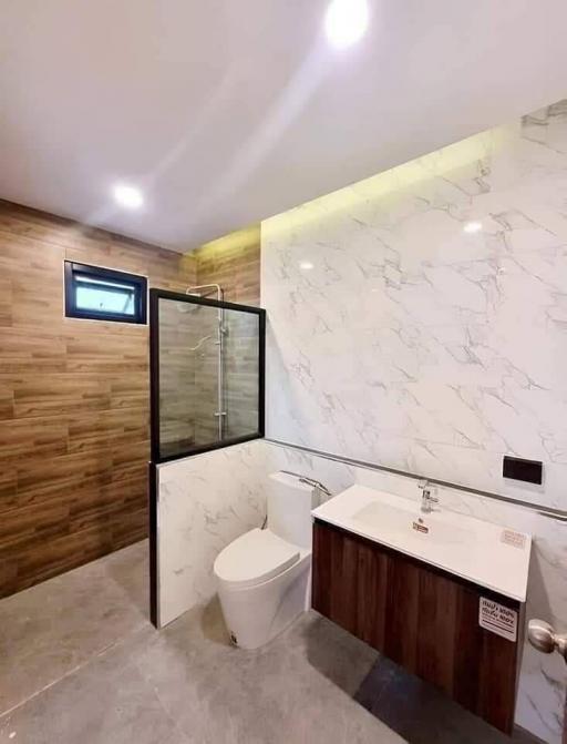 Modern bathroom with wood accents and marble wall tile