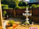 Cozy garden area with a water fountain, seating, and greenery