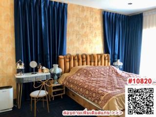 Elegant bedroom with rich blue curtains and golden textured wallpaper