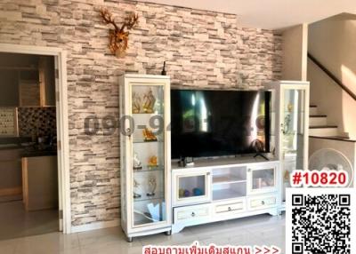 Spacious living room with stone accent wall and mounted TV