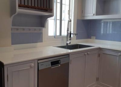 Modern kitchen with stainless steel appliances and blue walls