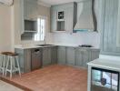 Modern kitchen with wooden cabinets and bar stool