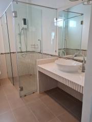 Modern bathroom with glass shower enclosure and vessel sink