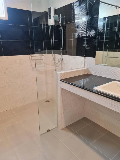 Modern bathroom with walk-in shower and sleek vanity