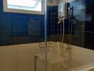Modern bathroom with glass shower enclosure and wall-mounted heater