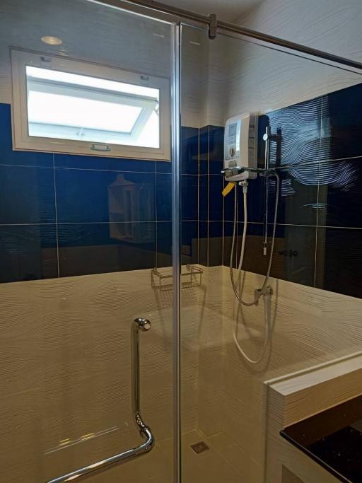 Modern bathroom with glass shower enclosure and wall-mounted heater
