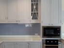 Modern kitchen with grey cabinets and built-in appliances