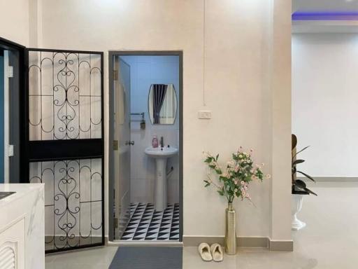 Interior view of a home showing entrance and bathroom door