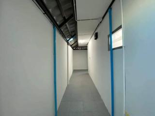 Bright and clean corridor with white walls and industrial ceiling