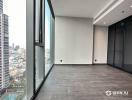 Spacious unfurnished living area with large windows and city view