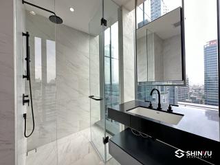 Modern bathroom with glass shower and city view