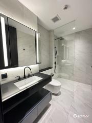 Modern bathroom with marble finish and walk-in shower