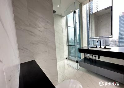 Modern bathroom with marble tiles and floor-to-ceiling windows