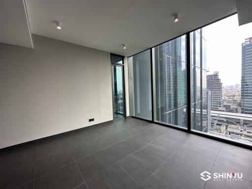 Empty modern living room with large windows and city view