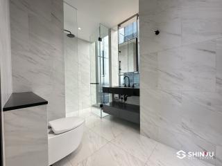 Modern bathroom with marble finishes and glass shower enclosure