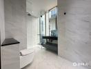 Modern bathroom with marble finishes and glass shower enclosure