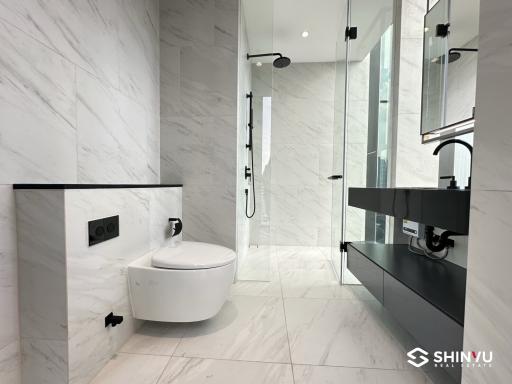 Modern bathroom with marble tiles and black fixtures