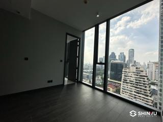 Spacious and bright empty room with large windows and a city view