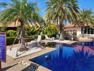 Tropical resort-style outdoor area with swimming pool and seating