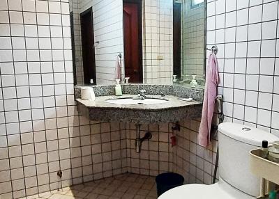 Compact bathroom with white tiles and a granite countertop