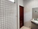 Spacious tiled bathroom with shower and vanity mirror