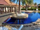 Elegant outdoor pool with curved design surrounded by a tropical garden