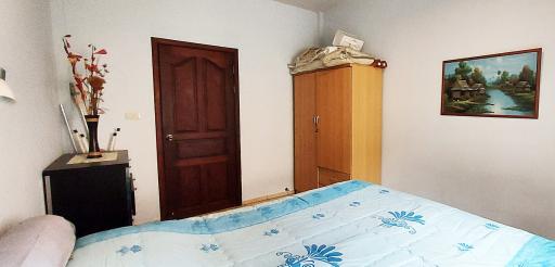 Cozy bedroom with wooden furniture and framed artwork