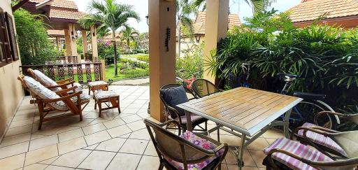 Cozy patio area with garden view, seating, and outdoor dining setup