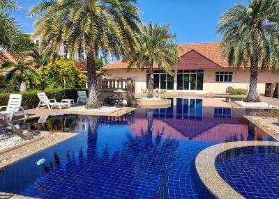 Luxury home exterior with swimming pool and palm trees