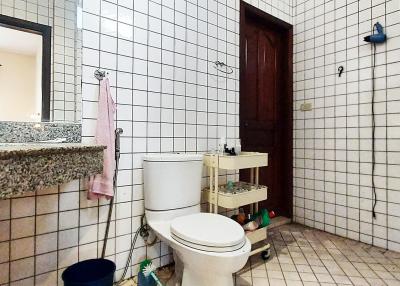 Spacious bathroom with tile walls and natural light