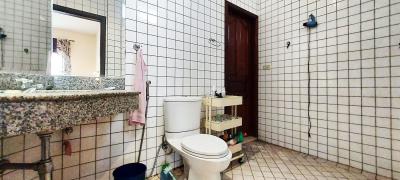 Spacious bathroom with tile walls and natural light