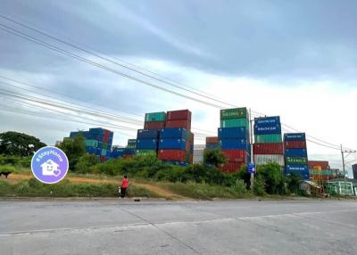 Exterior view of a property with stacked shipping containers and an open sky