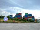 Exterior view of a property with stacked shipping containers and an open sky