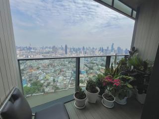 High-rise balcony with panoramic city view and potted plants