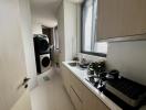 Compact modern kitchen with integrated appliances and laundry area