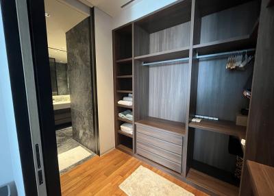 Modern bedroom interior with built-in wardrobe and adjoining bathroom