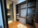 Modern bedroom interior with built-in wardrobe and adjoining bathroom