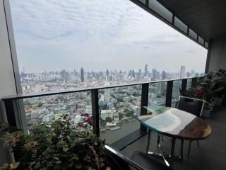 Spacious balcony with city skyline view and outdoor seating