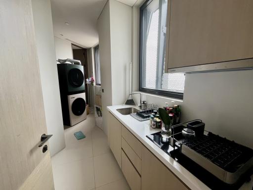 Modern kitchen with built-in appliances and laundry area