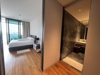 Modern bedroom with connecting bathroom in urban apartment
