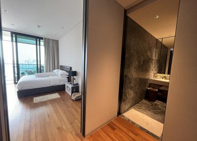 Modern bedroom with connecting bathroom in urban apartment