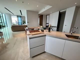 Modern kitchen with open floor plan leading to living area