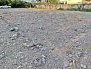 Empty residential lot with clear ground and scattered rocks