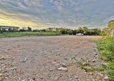 Empty plot of land with a cloudy sky at sunset, potential building site