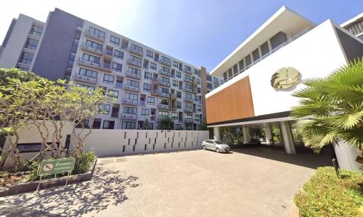 Modern residential building with parking facilities and lush greenery