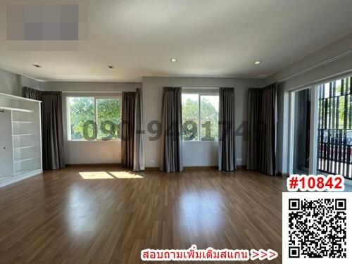 Spacious living room with large windows and hardwood floors