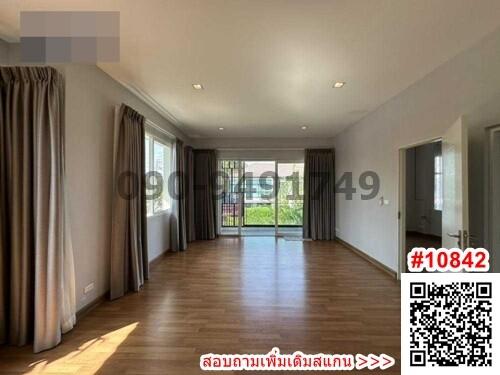 Spacious living room with large windows and hardwood floors