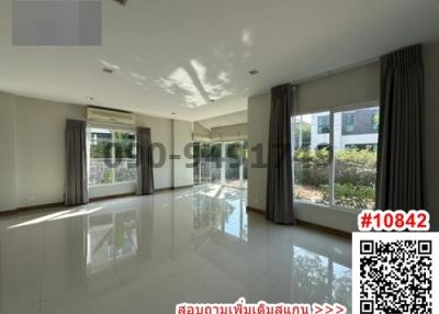 Spacious and bright living room with large windows and reflective floor
