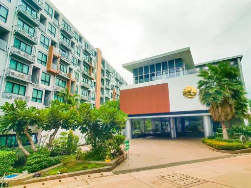 Exterior view of a modern apartment building with surrounding greenery